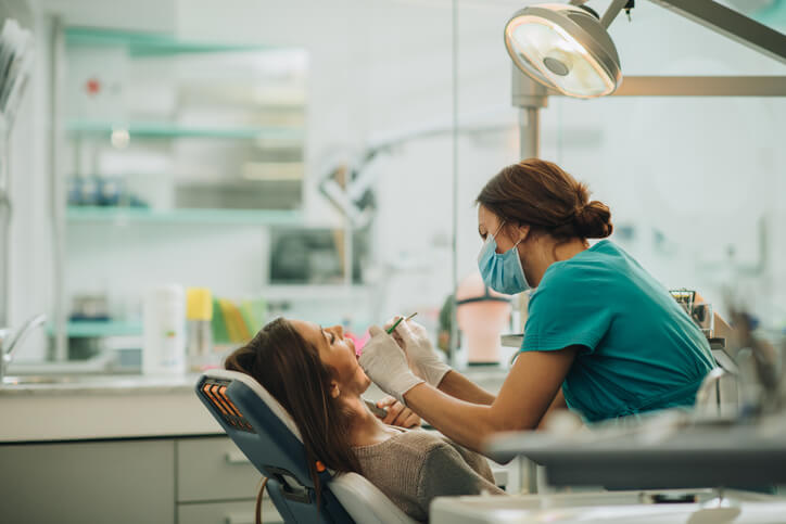 Young woman having her teeth checked during appointment at dentist's office